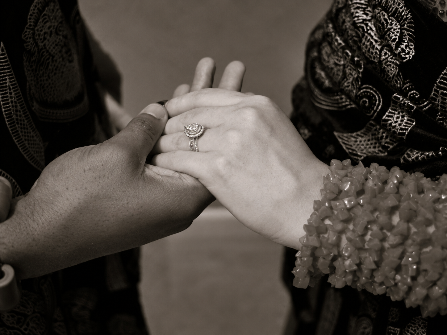 Tiffany and Ekene holding hands and showing their engagement ring
